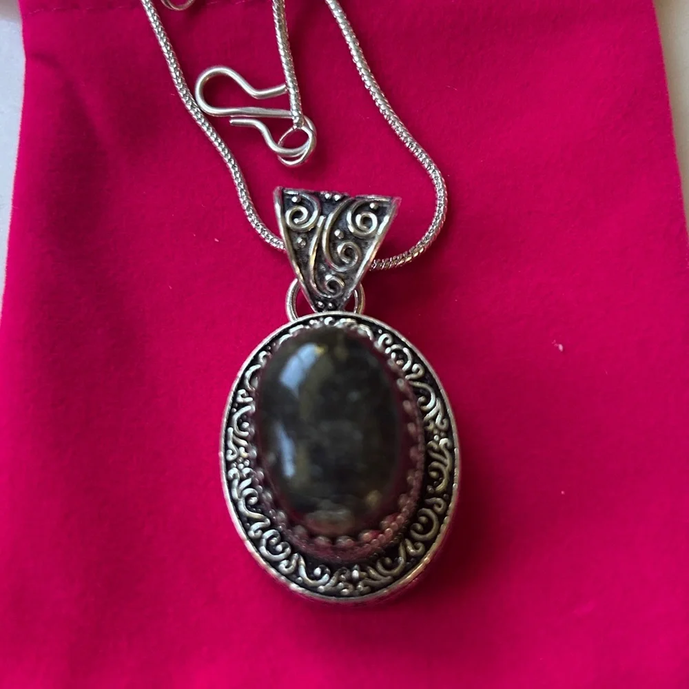 Vintage dark brown black agate pendant with a sterling silver setting.
